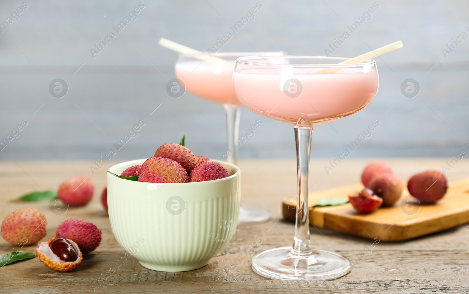 Photo of Delicious lychee cocktails and fresh fruits on wooden table