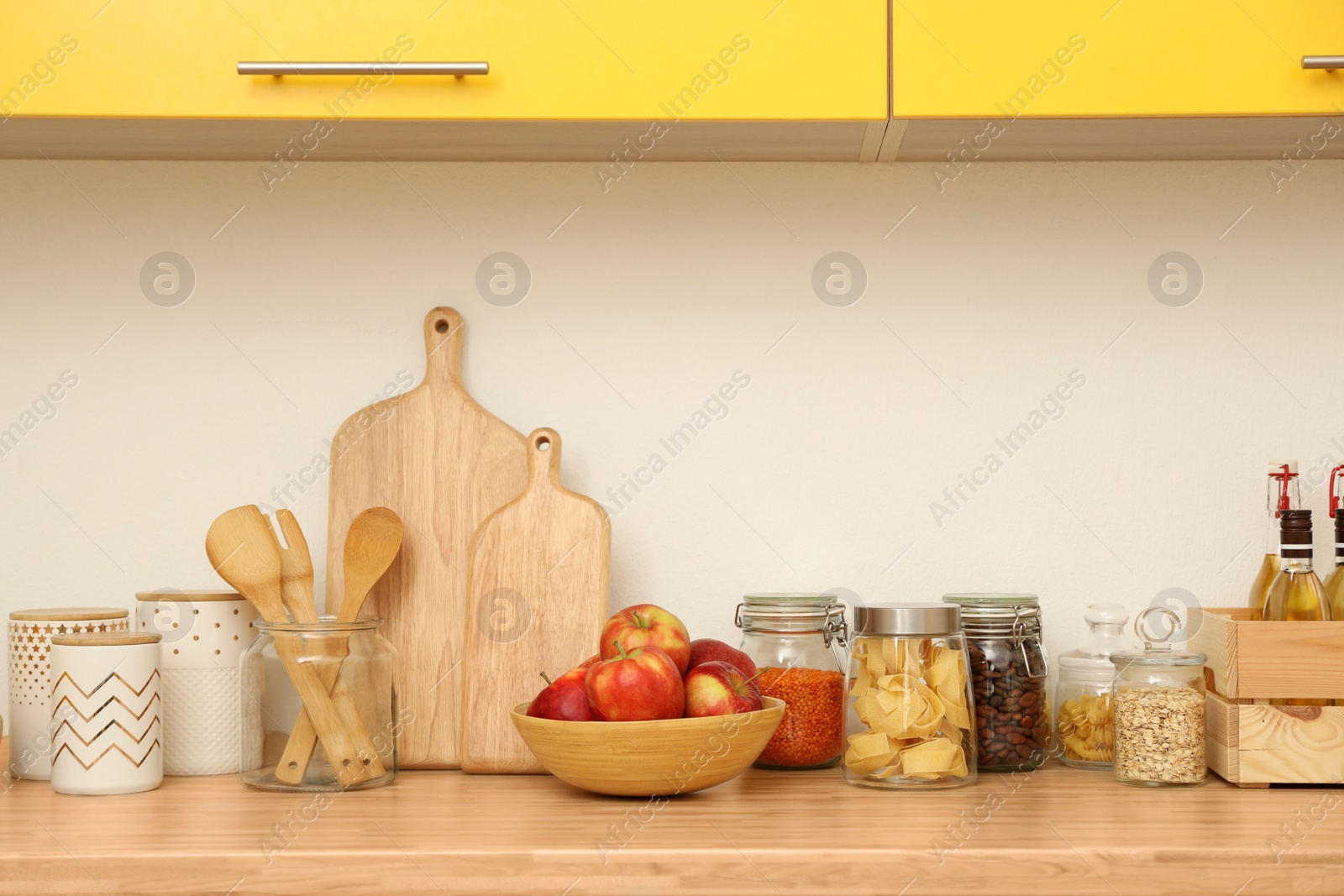 Photo of Stylish kitchen interior with wooden countertop and wall cabinets