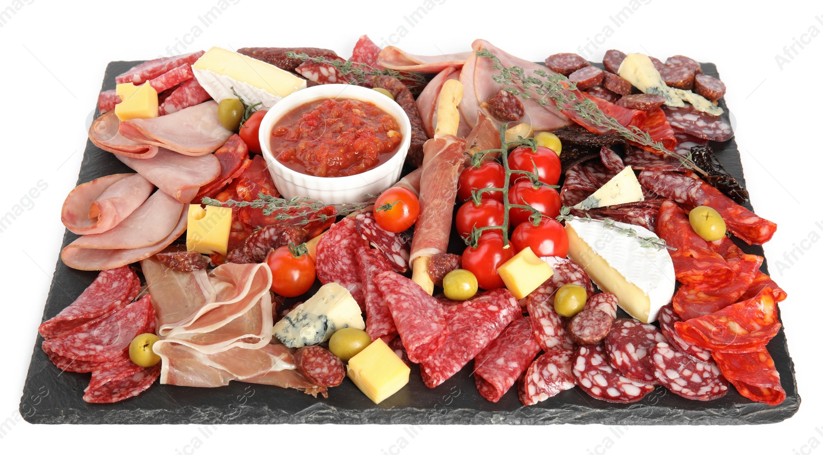 Photo of Slate plate with prosciutto and other delicacies isolated on white