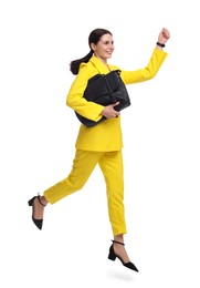Photo of Beautiful businesswoman in yellow suit with briefcase jumping on white background