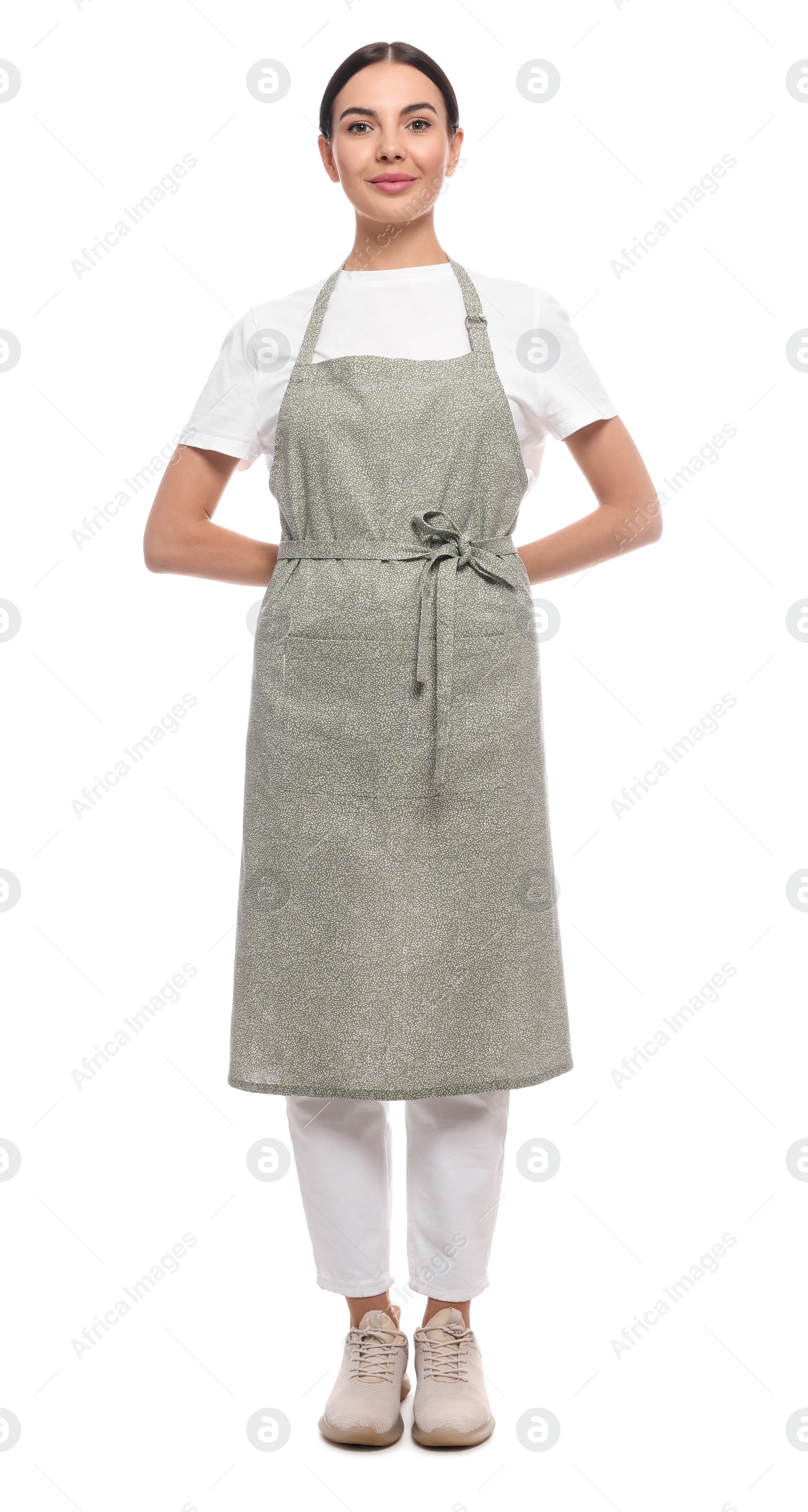 Photo of Young woman in light green apron on white background