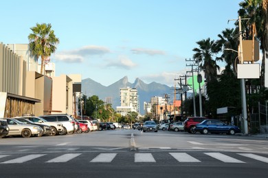 Picturesque view of city street with cars on road near beautiful buildings