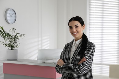 Photo of Portrait of receptionist near countertop in office, space for text