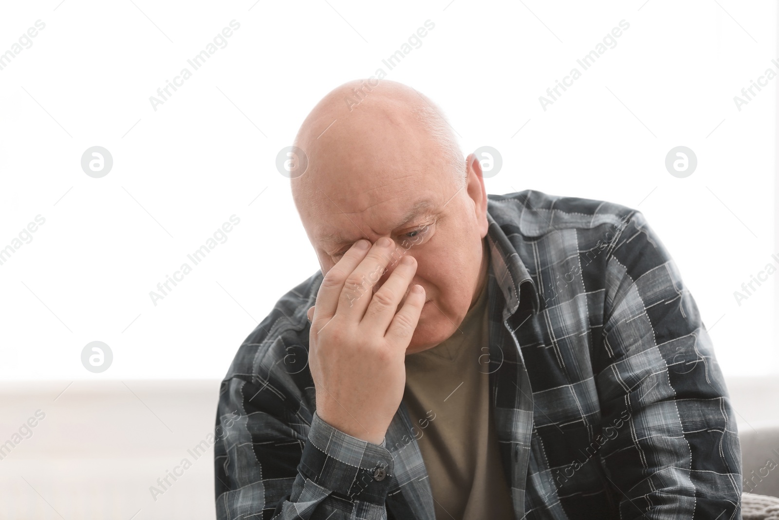 Photo of Senior man in state of depression indoors