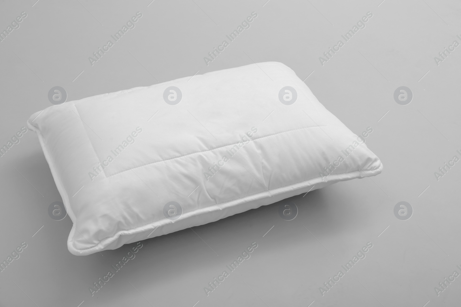 Photo of Clean soft bed pillow on grey background