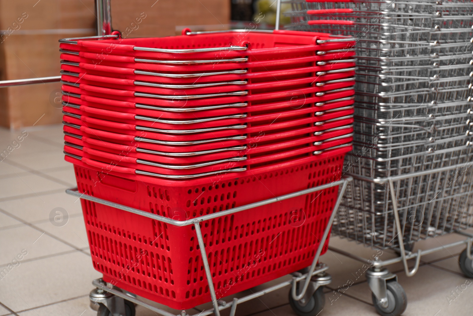 Photo of Stack of empty shopping baskets in supermarket, closeup