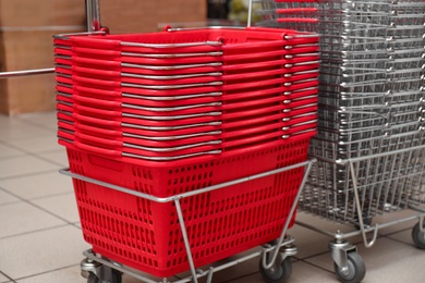 Stack of empty shopping baskets in supermarket, closeup