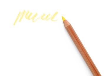 Photo of Yellow pastel pencil and scribble isolated on white, top view. Drawing supply