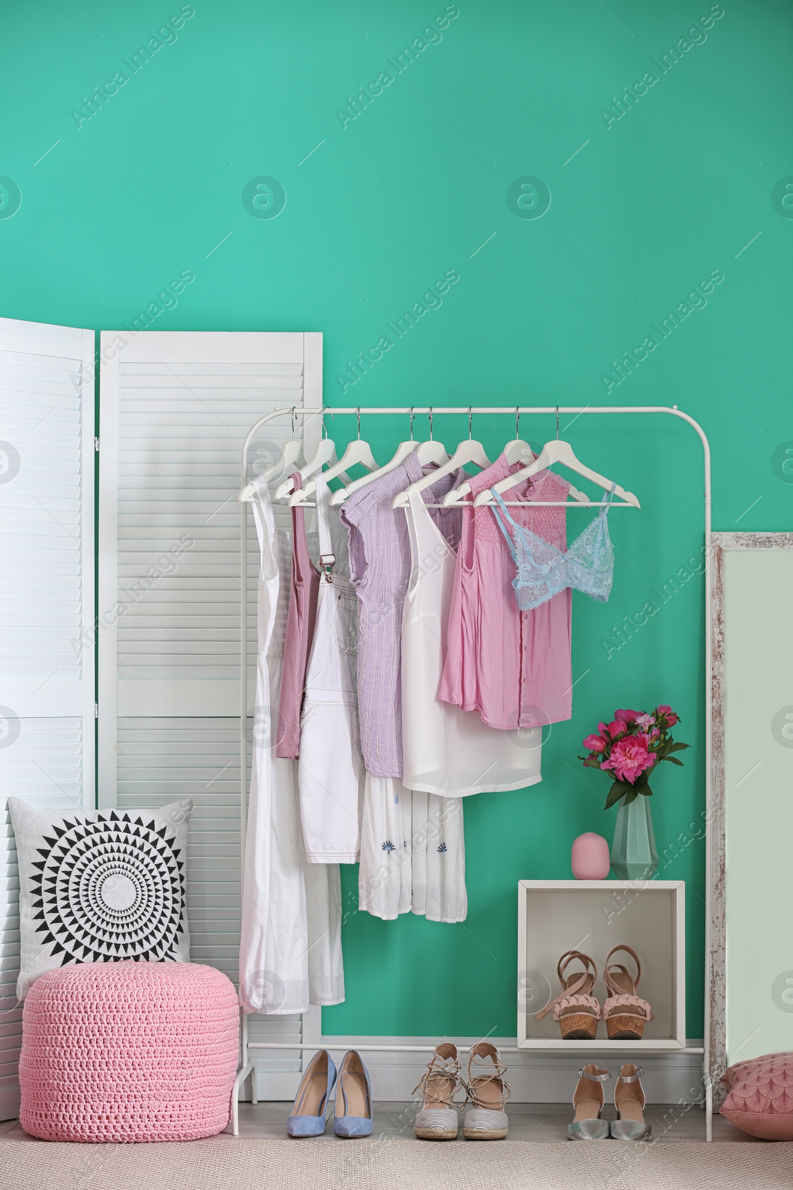 Photo of Stylish dressing room interior with clothes rack