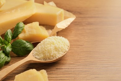 Photo of Delicious parmesan cheese on wooden table, space for text