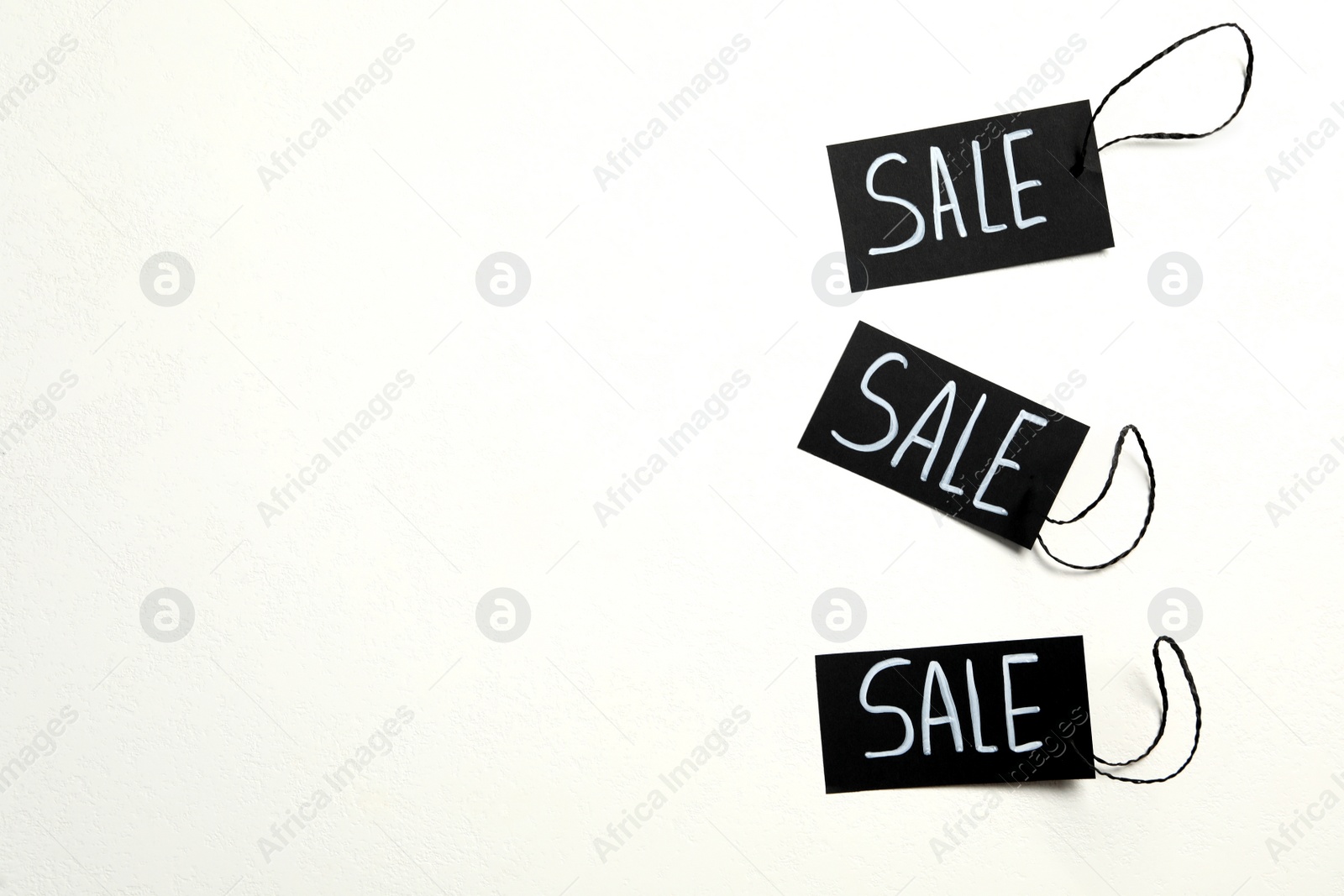 Photo of Tags with word SALE on white background. Black Friday concept