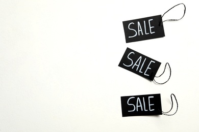 Photo of Tags with word SALE on white background. Black Friday concept
