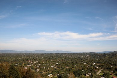 Picturesque view of cityscape and mountains under blue sky