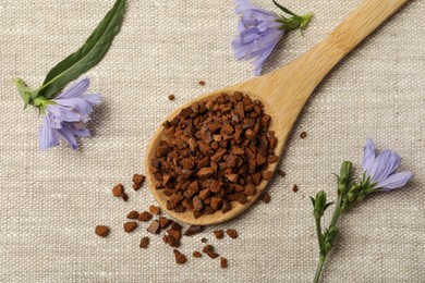 Photo of Spoon of chicory granules and flowers on sackcloth, flat lay
