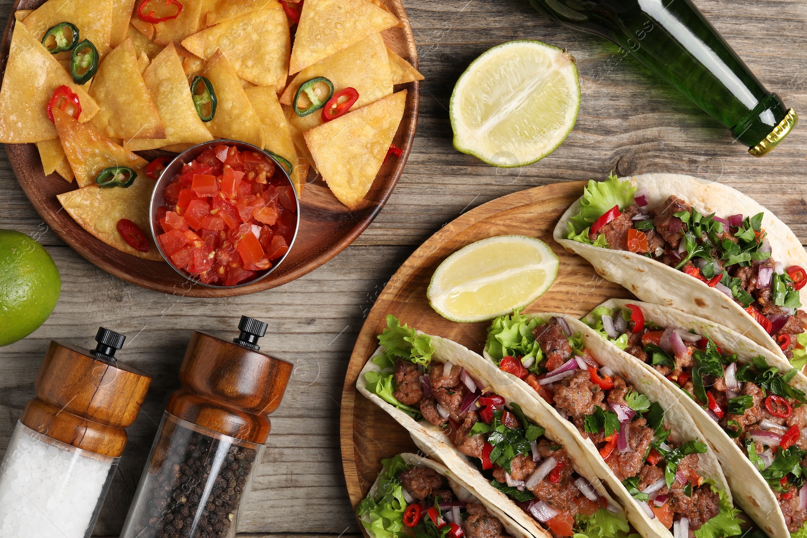 Photo of Flat lay composition with delicious tacos on wooden table