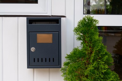 Photo of New metal grey mailbox outdoors on autumn day, space for text