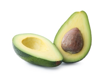 Photo of Halves of ripe avocado with pit on white background