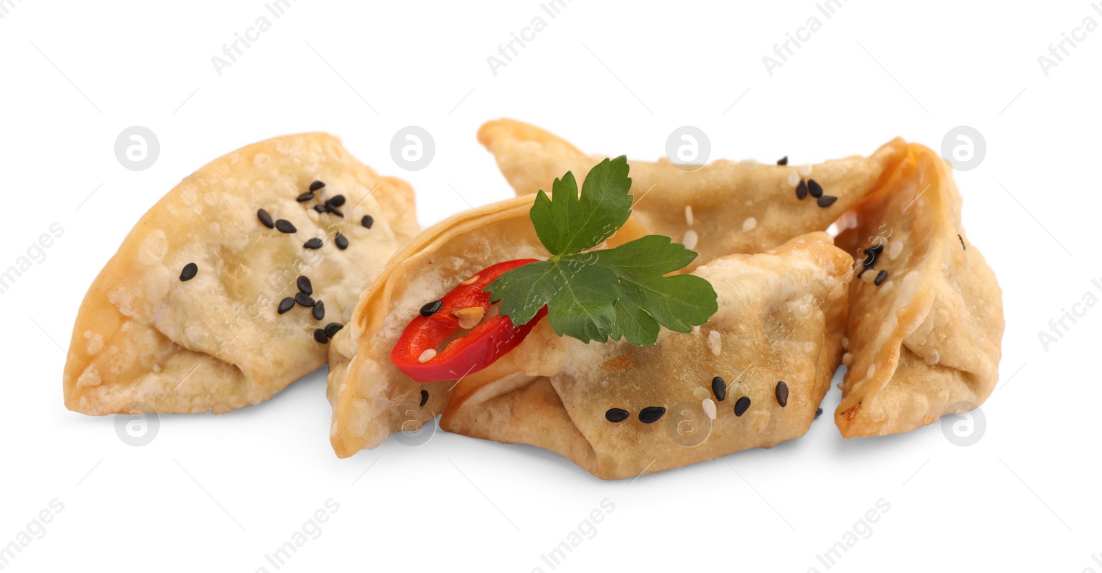 Photo of Delicious gyoza (asian dumplings) with sesame, parsley and pepper isolated on white