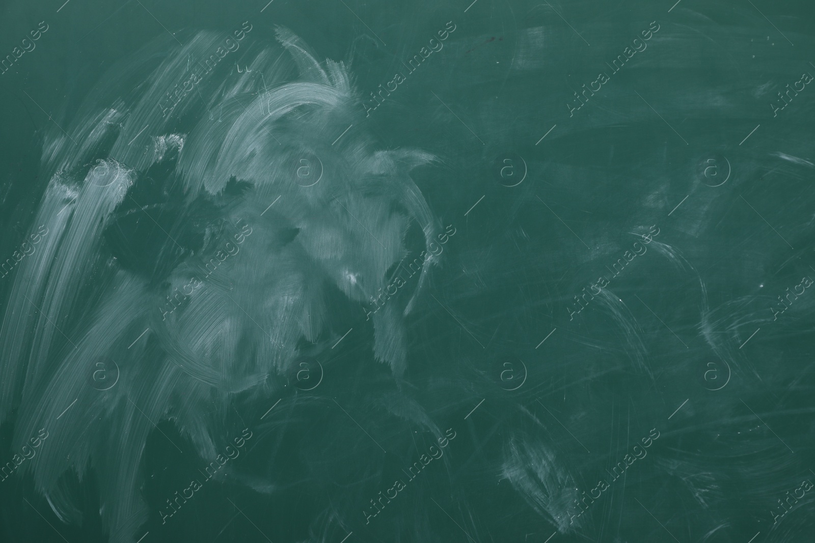 Photo of Chalk rubbed out on green chalkboard as background, closeup. Space for text