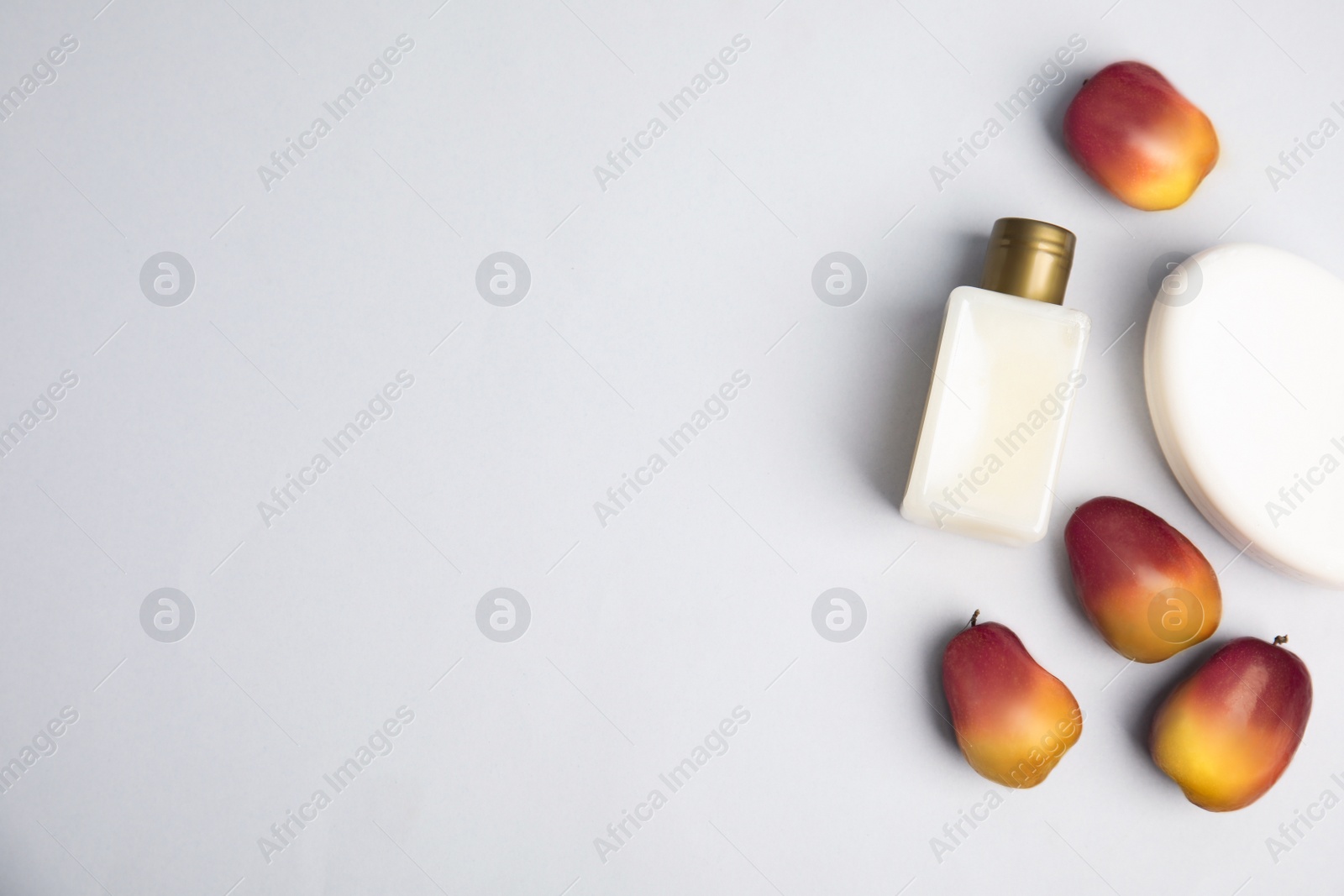 Image of Fresh ripe palm oil fruits and cosmetic products on white background, flat lay. Space for text