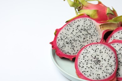Photo of Delicious cut and whole dragon fruits (pitahaya) on white background, closeup