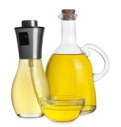 Photo of Bottles and bowl of cooking oil on white background