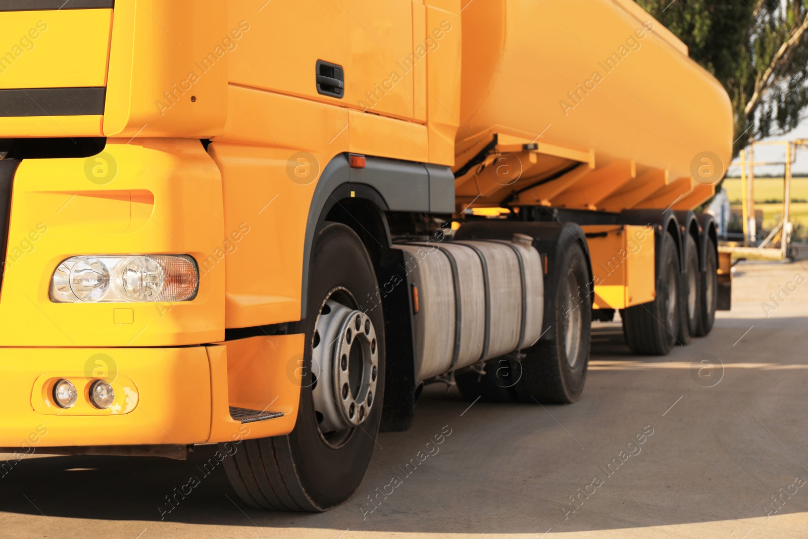 Photo of Modern yellow truck parked on country road, closeup