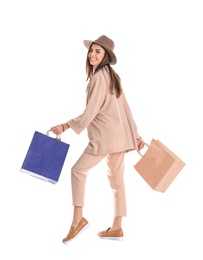 Photo of Young woman with shopping bags on white background