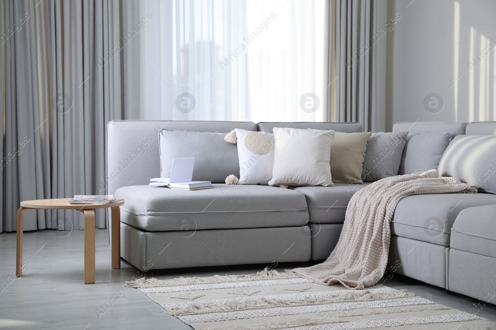 Photo of Living room interior with large grey sofa