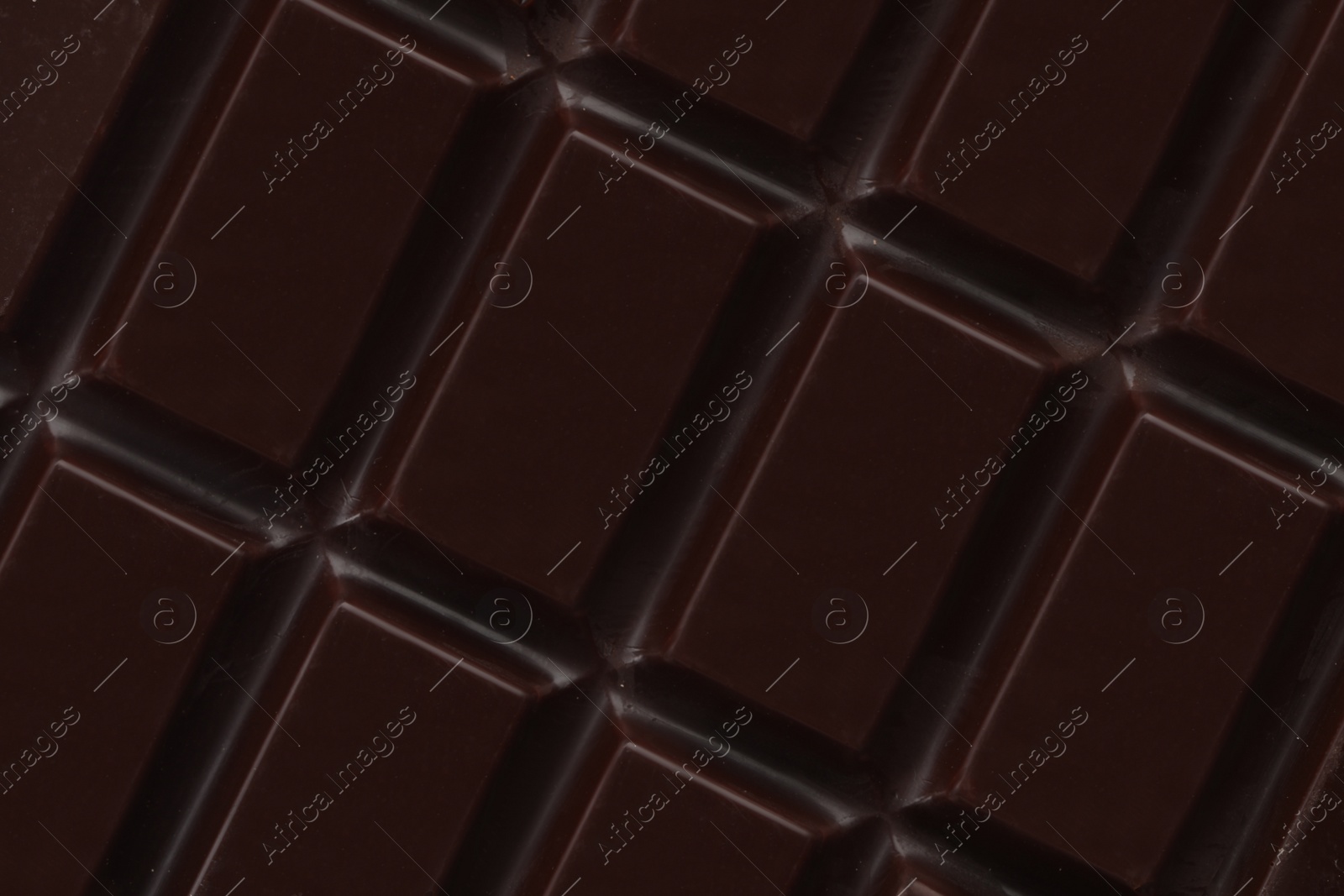 Photo of Delicious dark chocolate as background, closeup view