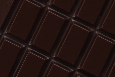 Photo of Delicious dark chocolate as background, closeup view