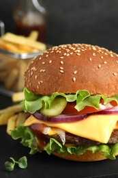 Delicious burger with beef patty on dark table, closeup