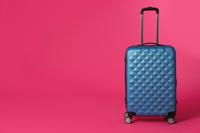 Stylish suitcase on color background. Space for text