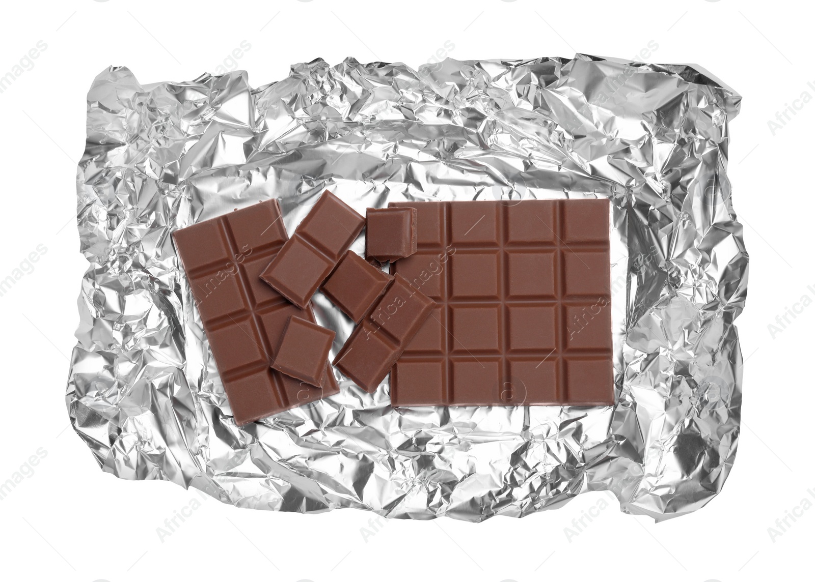 Photo of Pieces of delicious milk chocolate bars with foil isolated on white, top view