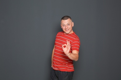 Photo of Portrait of happy mature man on dark background