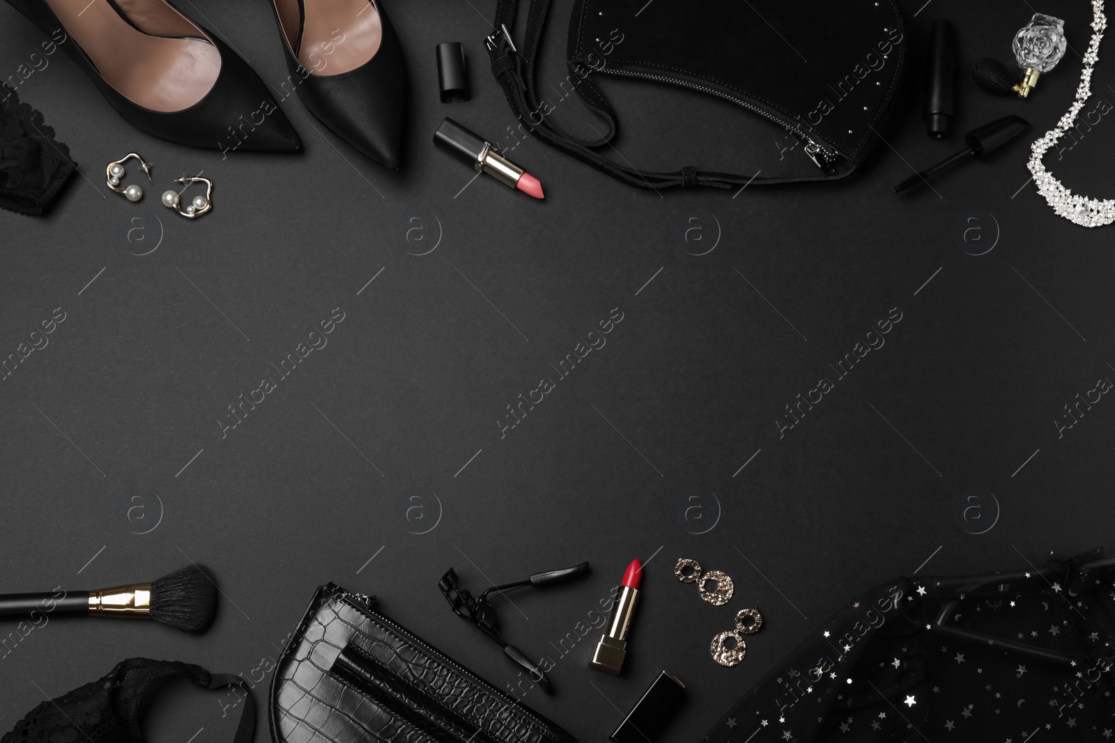 Photo of Women's clothes, makeup products and accessories on dark background, flat lay with space for text. Black Friday sale