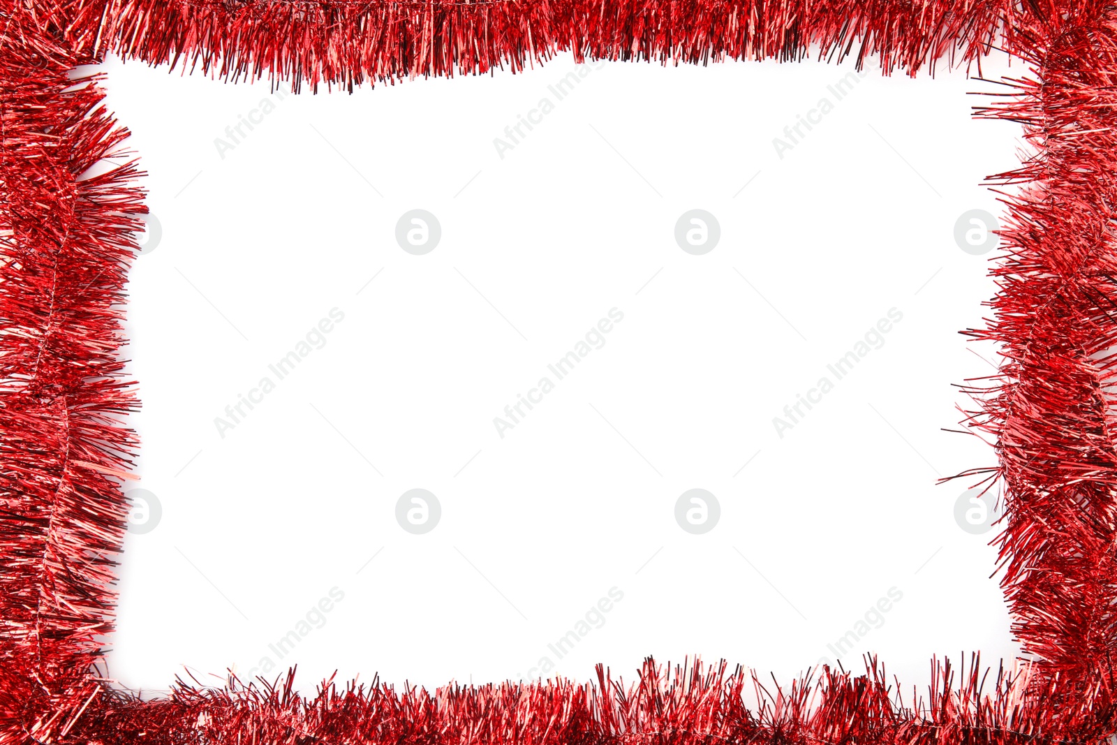 Photo of Frame of shiny red tinsel on white background, top view. Space for text