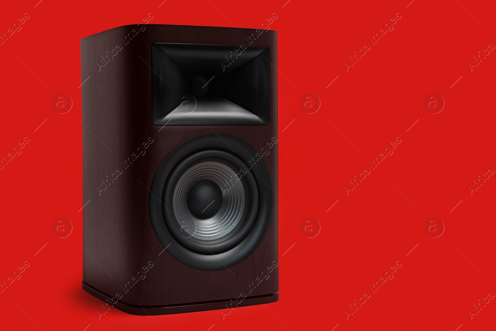 Photo of One wooden sound speaker on red background. Space for text