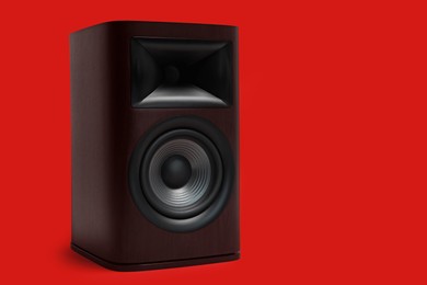 Photo of One wooden sound speaker on red background. Space for text