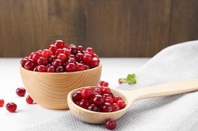 Photo of Fresh ripe cranberries on white wooden table, closeup