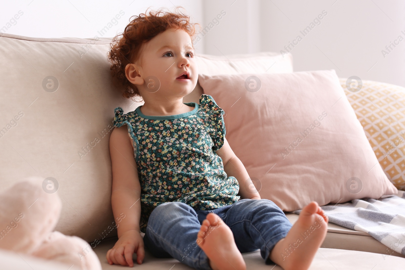 Photo of Portrait of cute little child on sofa at home