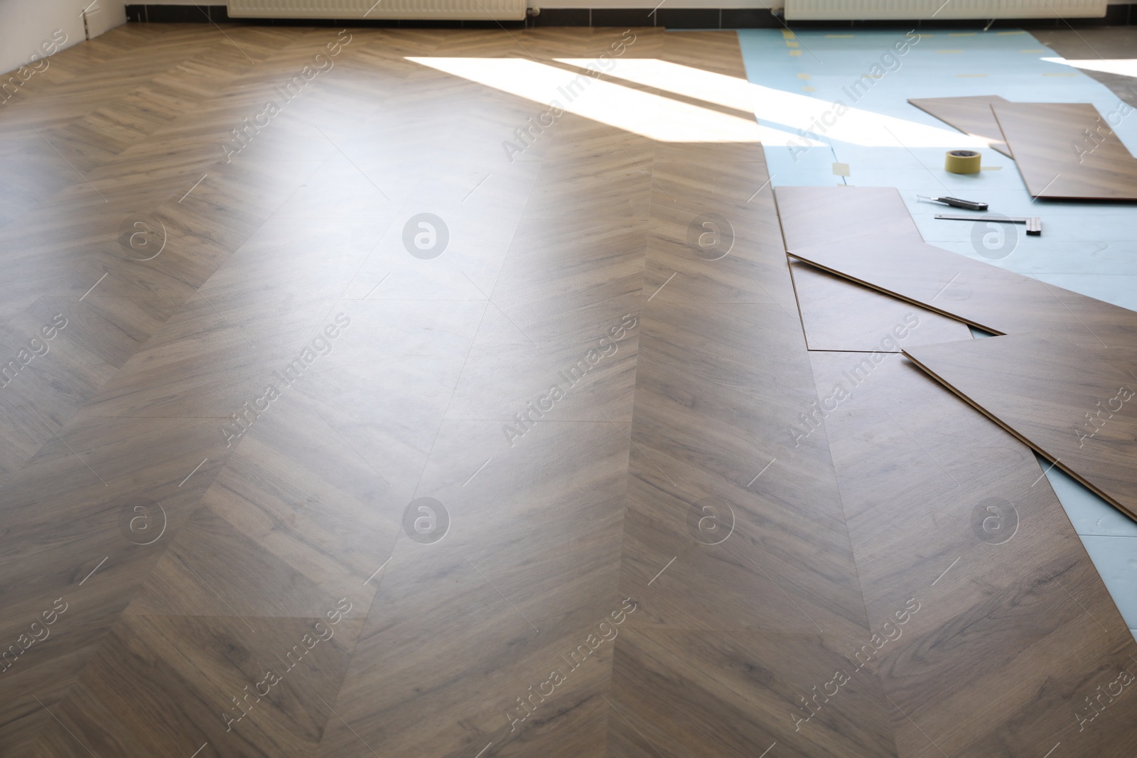 Photo of Installation of laminated wooden floor at home