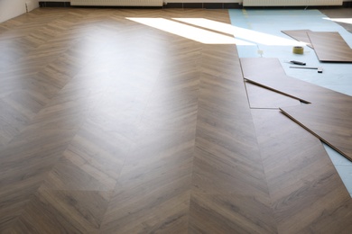 Photo of Installation of laminated wooden floor at home