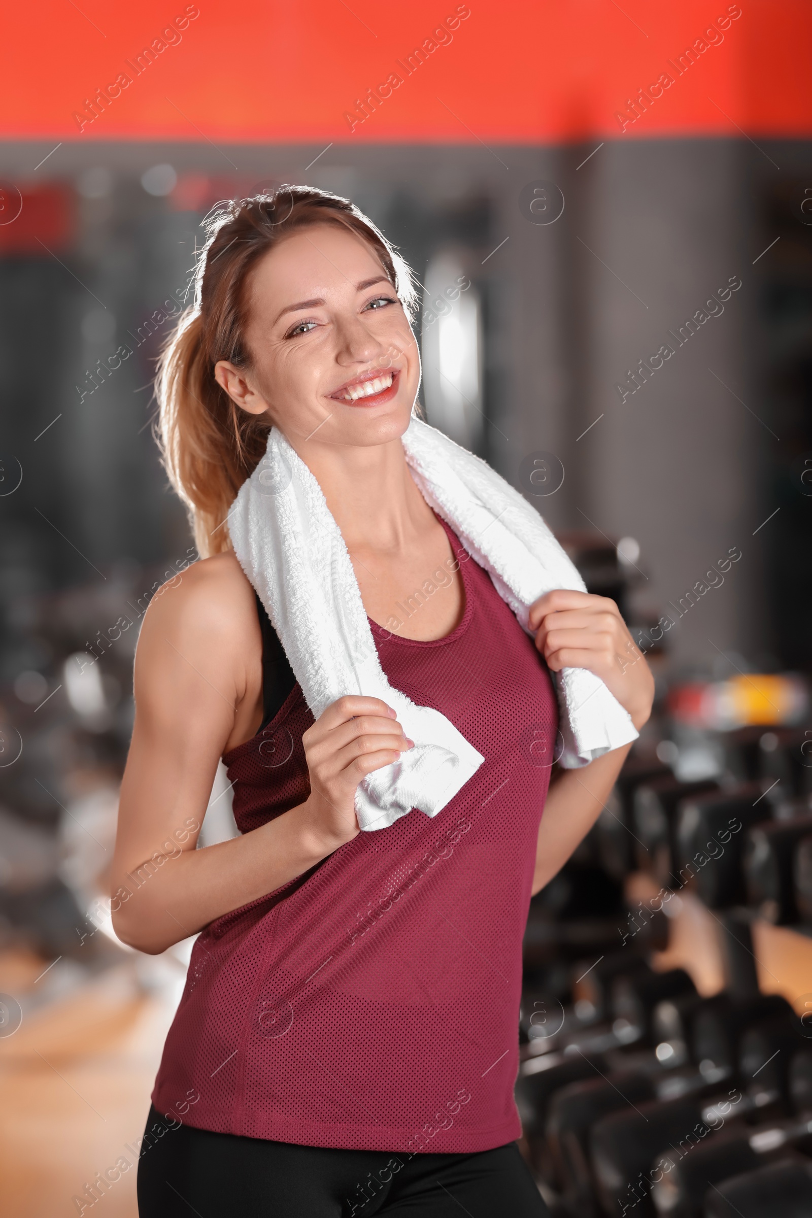Photo of Beautiful young woman with towel in gym