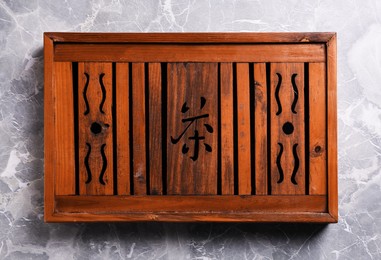Photo of Wooden tray for traditional tea ceremony on light grey marble table, top view