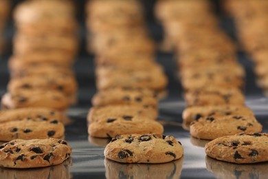 Photo of Many delicious cookies on production line, closeup