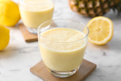 Photo of Glass with healthy detox smoothie and ingredients on table