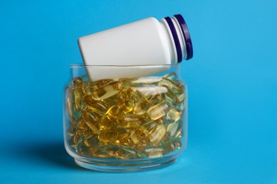 Medical bottles and pills on light blue background