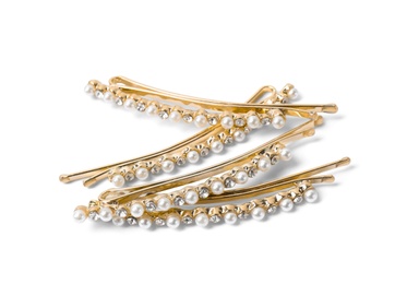 Photo of Many beautiful gold hair pins with gems on white background