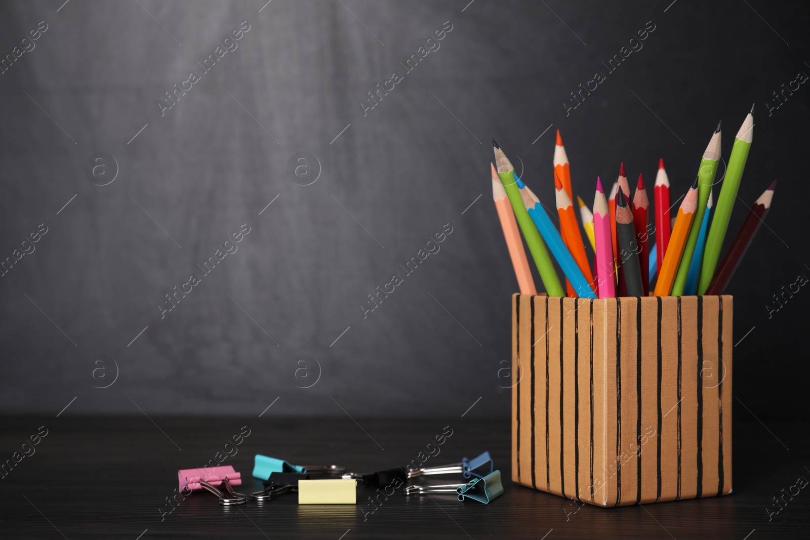 Photo of School stationery on black wooden table, space for text. Doing homework